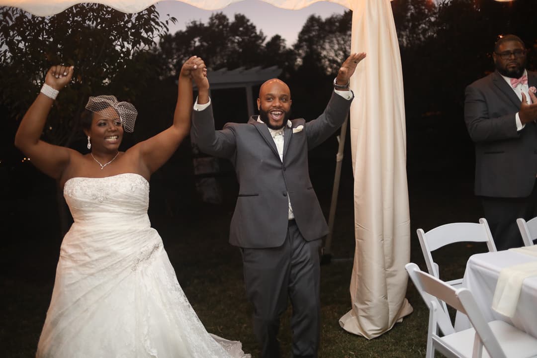 A couple raising their hands in celebration after the ceremony